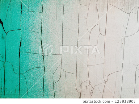 Vintage abstract background with old fence with cracked and peeling paint in green white colours. Fragment of the weathered rough wall backdrop. 125938905