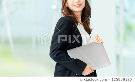 Smiling woman/businesswoman with a laptop Smiling woman/businesswoman with a laptop 125939180