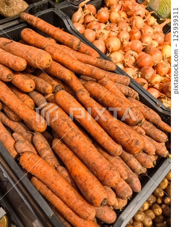 Harvested carrots displayed at a vibrant market in autumn sunlight 125939311