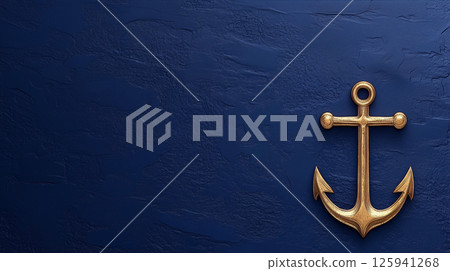 Golden anchor on textured dark blue background with copy space for nautical decor theme 125941268