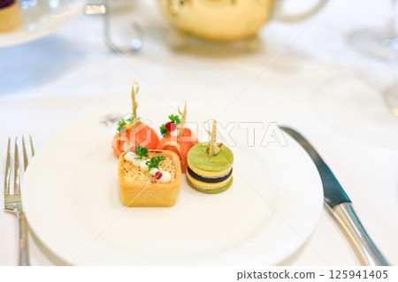 Dessert, cake, canape, macarons and sweets to accompany afternoon tea. 125941405