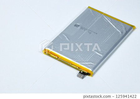 damaged swollen Lithium polymer, Li-ion batteries for mobile device isolated on white background. damaged swollen Lithium polymer, Li-ion batteries for mobile device isolated on white background. 125941422