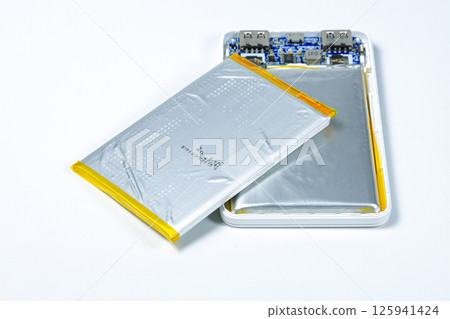 damaged swollen Lithium polymer, Li-ion batteries for mobile device isolated on white background. damaged swollen Lithium polymer, Li-ion batteries for mobile device isolated on white background. 125941424