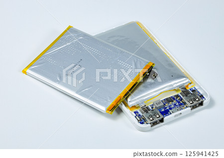 damaged swollen Lithium polymer, Li-ion batteries for mobile device isolated on white background. damaged swollen Lithium polymer, Li-ion batteries for mobile device isolated on white background. 125941425