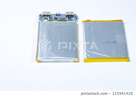 damaged swollen Lithium polymer, Li-ion batteries for mobile device isolated on white background. damaged swollen Lithium polymer, Li-ion batteries for mobile device isolated on white background. 125941428
