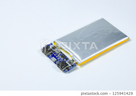 damaged swollen Lithium polymer, Li-ion batteries for mobile device isolated on white background. damaged swollen Lithium polymer, Li-ion batteries for mobile device isolated on white background. 125941429