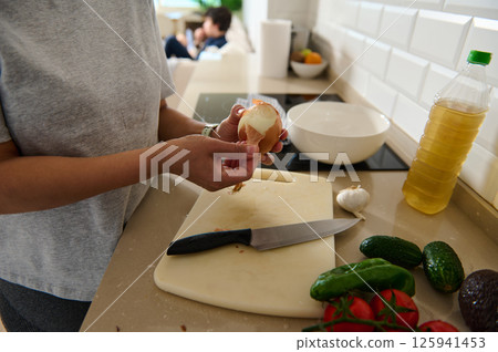 Person Preparing Vegetables and Ingredients in a Modern Kitchen Person Preparing Vegetables and Ingredients in a Modern Kitchen 125941453