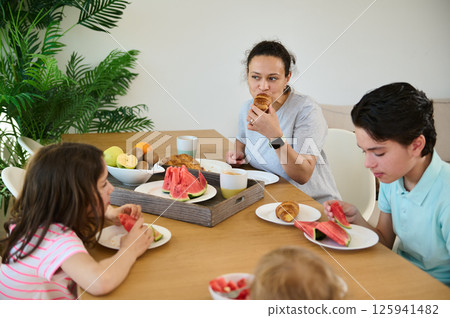Family Enjoying a Healthy Breakfast Together in a Bright Modern Kitchen 125941482