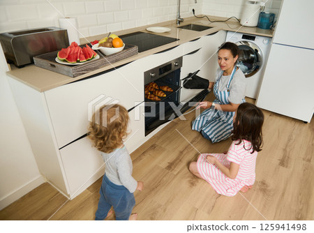 Mother Baking Fresh Croissants at Home With Her Children in the Kitchen Mother Baking Fresh Croissants at Home With Her Children in the Kitchen 125941498