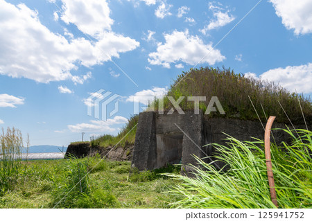 The remains of the northern air raid shelter of the former Japanese military's Yanagimoto Airfield, standing in a rice paddy area before rice planting 125941752