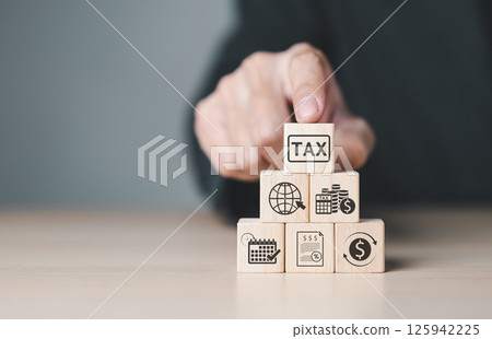 Tax and Financial Planning. taxation and financial management, Wooden blocks showcase tax, budgeting, savings, global finance, and investment concepts. Accounting, business taxation, economic strategy Tax and Financial Planning. taxation and financial management, Wooden blocks showcase tax, budgeting, savings, global finance, and investment concepts. Accounting, business taxation, economic strategy 125942225