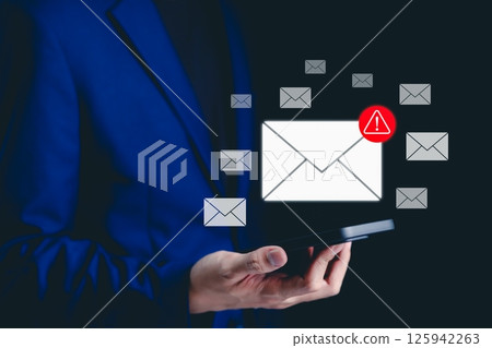 Email security warning notification concept. A person using a smartphone with email security alert icons and warning notifications, indicating cybersecurity threats, spam, viruses, junk mail, scams, 125942263