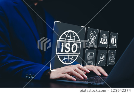 ISO Certification Concept. Businessman working on a laptop with ISO certification, icons symbolizing quality assurance, compliance, global standards, and International organization for standardization 125942274