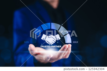 Trusted Partner and Business Collaboration Concept. Businessman holding glowing handshake icon with a trust level gauge, business partnership, reliability, and professional collaboration. trustworthy, Trusted Partner and Business Collaboration Concept. Businessman holding glowing handshake icon with a trust level gauge, business partnership, reliability, and professional collaboration. trustworthy, 125942304