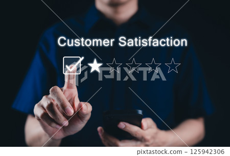 Negative customer review concept. A person use smartphone to give a one-star rating, symbolizing customer dissatisfaction, negative feedback, and online reviews in business reputation. 1 star score, Negative customer review concept. A person use smartphone to give a one-star rating, symbolizing customer dissatisfaction, negative feedback, and online reviews in business reputation. 1 star score, 125942306