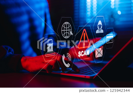 Scam Alert Warning with Cybersecurity Icons. Man holding smartphone while using laptop, warning sign for scams with icons online threats, phishing, cybersecurity, Unknown person, suspicious scammer, 125942344