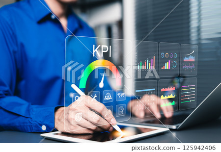 KPI Concept. Analyzing Key Performance Indicators. Businessman using digital screen to analyze key performance indicators (KPI) with various graphs and charts, data analysis, and performance tracking. KPI Concept. Analyzing Key Performance Indicators. Businessman using digital screen to analyze key performance indicators (KPI) with various graphs and charts, data analysis, and performance tracking. 125942406