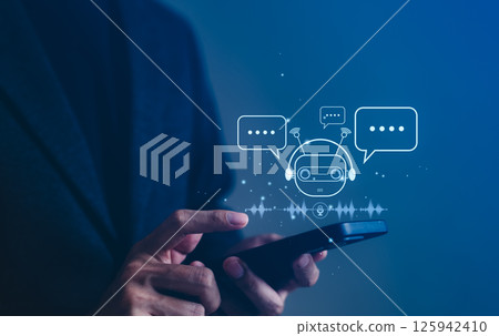 AI Chatbot and Voice Assistant Communication Concept. A person interacts with smartphone digital Chat AI and voice assistant icon, AI-powered conversation, customer support, and smart interaction. AI Chatbot and Voice Assistant Communication Concept. A person interacts with smartphone digital Chat AI and voice assistant icon, AI-powered conversation, customer support, and smart interaction. 125942410