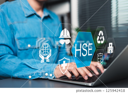 HSE Concept for Workplace Health and Safety. Businessman using laptop with icons representing health, safety, and environmental protection, illustrating HSE management system in business. work safety, 125942418