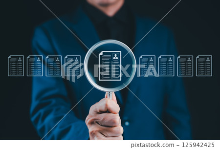 Resume Screening and Candidate Evaluation Concept. Businessman holding magnifying glass on resume icons, recruitment, candidate screening, human resources, employee evaluation, HR document analysis, Resume Screening and Candidate Evaluation Concept. Businessman holding magnifying glass on resume icons, recruitment, candidate screening, human resources, employee evaluation, HR document analysis, 125942425
