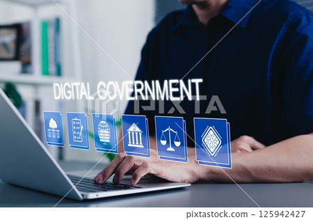 Digital government transformation and online public services. A person using laptop with digital government icons cloud data, regulation, law, online services, E-government innovation transformation. 125942427