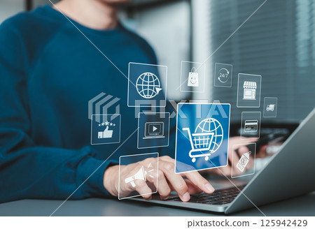 Online shopping and e-commerce concept. A man using laptop and phone with ecommerce icons, shopping cart, discount tag, and delivery truck, online shopping, internet retail, digital marketing, shop, 125942429