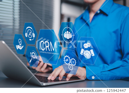 CRM Customer Relationship Management Concept. Businessman using laptop with CRM icons representing customer support, service, relationship building, sales, and marketing automation tools software. 125942447