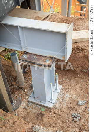 Concrete foundations support metal columns 125942555