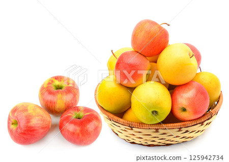 Ripe juicy apples in a wicker basket isolated on white background. 125942734