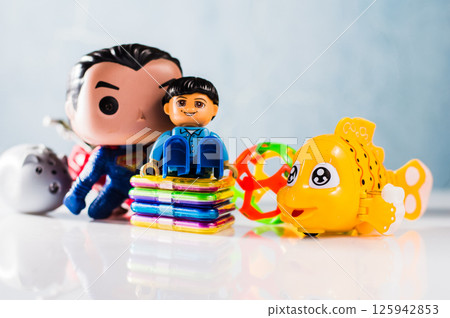 The plastic fish stands out among the colored game elements. The plastic fish stands out among the colored game elements. 125942853