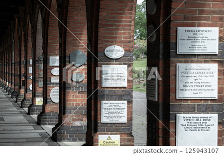 Perspective of Red brick columns and arches an Historic Building in Golders Green Crematorium and Mausoleum. Perspective of Red brick columns and arches an Historic Building in Golders Green Crematorium and Mausoleum. 125943107