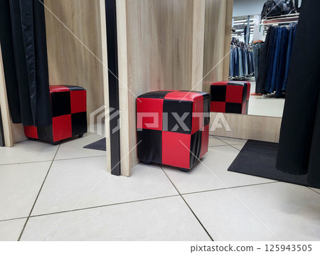 Red and black square pouf in the store in the fitting booth 125943505