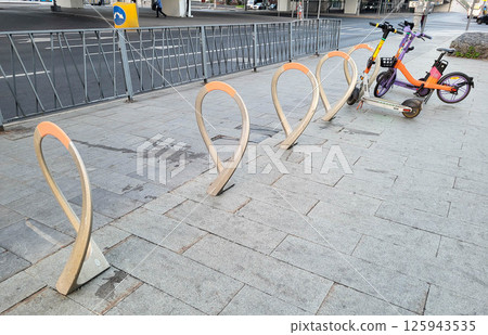 Outdoor parking for bicycles and delivery scooters Outdoor parking for bicycles and delivery scooters 125943535