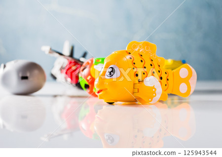 A yellow plastic fish. 125943544