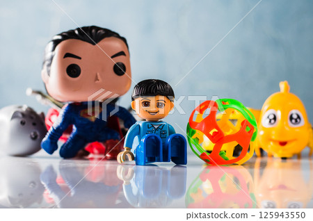 Among the toys in the photo you can see a yellow fish made of plastic. Among the toys in the photo you can see a yellow fish made of plastic. 125943550