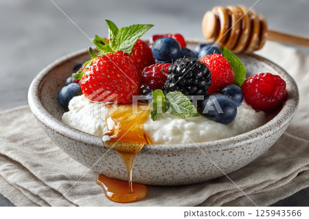 Bowl of traditional skyr topped with fresh berries and honey 125943566