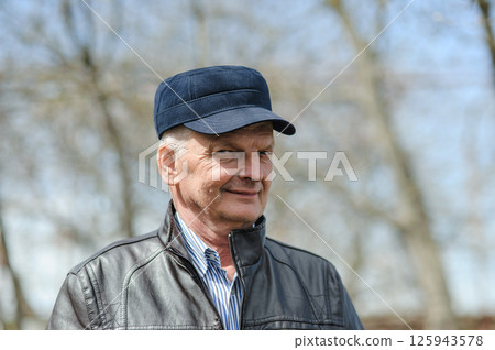 Gray-haired pensioner smiling beautifully. Strong elderly man on the street. Gray-haired pensioner smiling beautifully. Strong elderly man on the street. 125943578