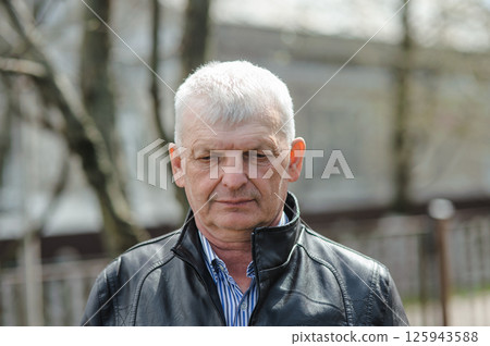 Portrait of a gray-haired old man in thought. The pensioner is upset. Portrait of a gray-haired old man in thought. The pensioner is upset. 125943588