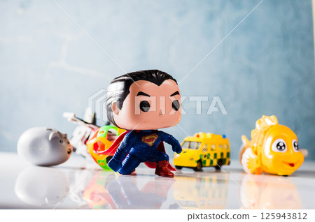 A bright plastic fish attracts attention in the foreground. A bright plastic fish attracts attention in the foreground. 125943812