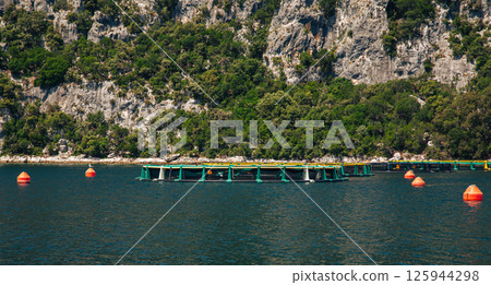 Aquaculture fish farm natural mountainous setting. Sustainable fishing seafood production concept Aquaculture fish farm natural mountainous setting. Sustainable fishing seafood production concept 125944298