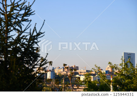Empty asphalt road and modern city skyline with building scenery at sunset. 125944331