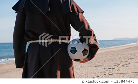 A Christian Priest Ready To Play with a soccer ball A Christian Priest Ready To Play with a soccer ball 125944475