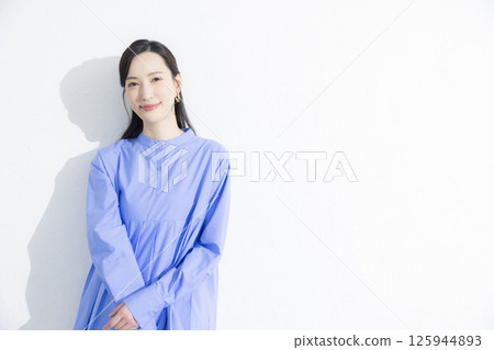 Woman wearing a blue dress 125944893