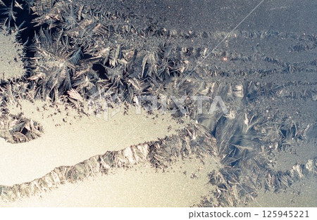 Frost flowers on a window pane Frost flowers on a window pane 125945221