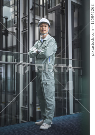 Image of a worker in his 40s with his arms folded looking at the camera, building maintenance staff Image of a worker in his 40s with his arms folded looking at the camera, building maintenance staff 125945268