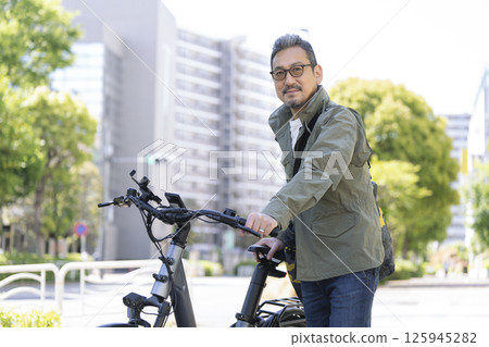 A man in his late 50s smiling at the camera 125945282