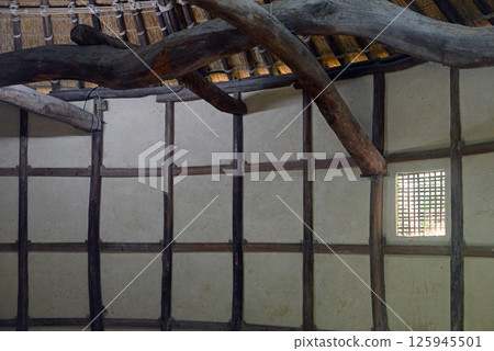 The mud walls and beams of a sugar-making hut from the early Meiji period in Shikokumura 125945501