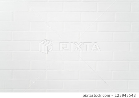 Clean white painted brick wall closeup with soft shadow detailing 125945548