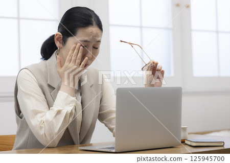 Tired middle-aged woman Tired middle-aged woman 125945700