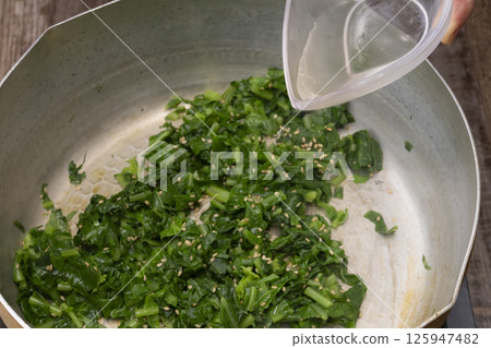 The process of making furikake with leaf radish. Stir-fried leaf radish. Leaf radish furikake. Stir-fried radish leaves. The process of making furikake with leaf radish. Stir-fried leaf radish. Leaf radish furikake. Stir-fried radish leaves. 125947482
